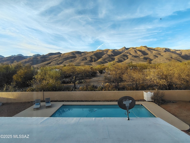 view of pool with fence, a mountain view, and a fenced in pool