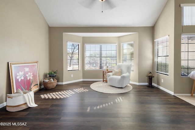 sitting room with lofted ceiling, baseboards, and wood finished floors