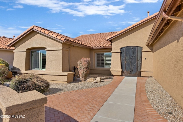 entrance to property featuring a patio area