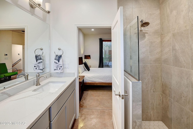 bathroom with vanity, tiled shower, and tile patterned floors