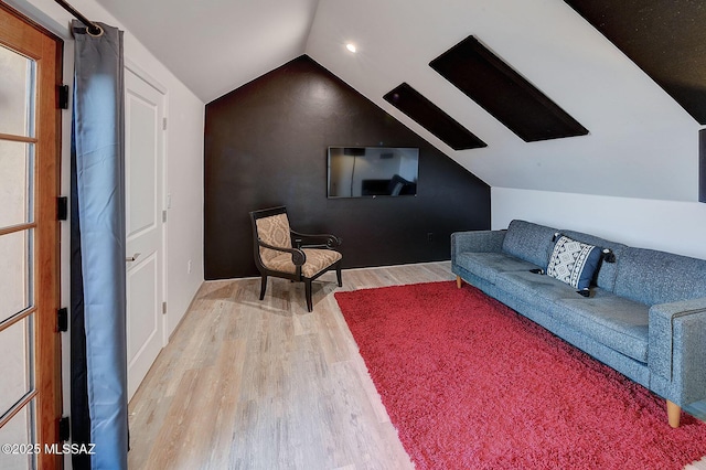 living room with lofted ceiling and hardwood / wood-style floors