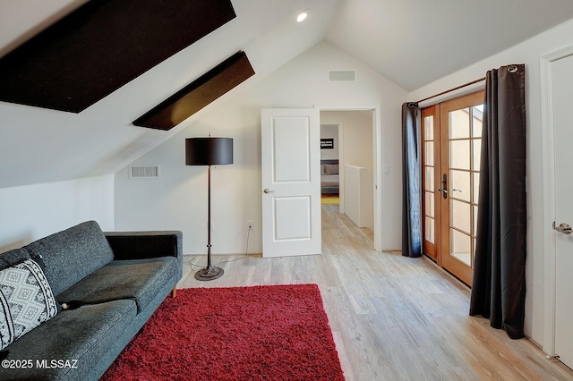 living room featuring vaulted ceiling and light wood-type flooring