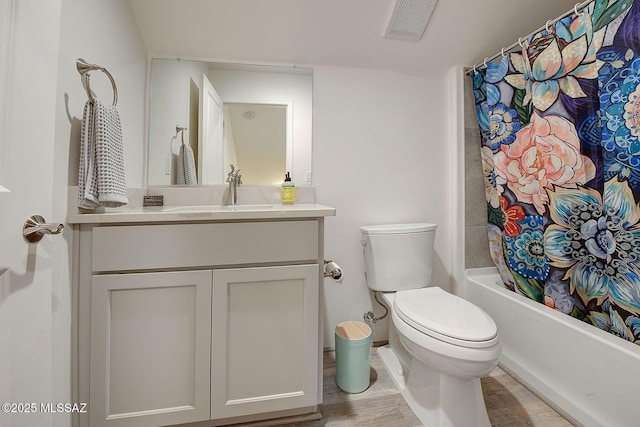 full bathroom featuring hardwood / wood-style flooring, vanity, toilet, and shower / bath combination with curtain