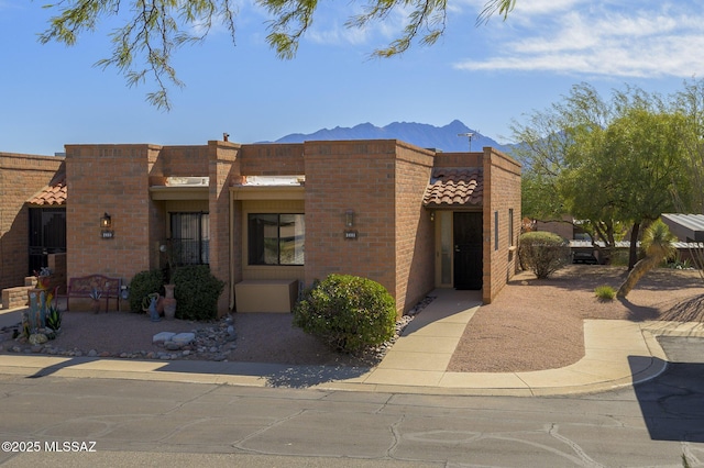 pueblo-style home featuring a mountain view