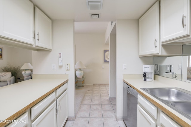 kitchen featuring white cabinetry, light tile patterned floors, sink, and dishwasher