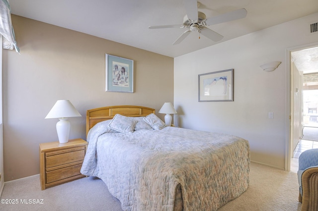 bedroom featuring light carpet and ceiling fan