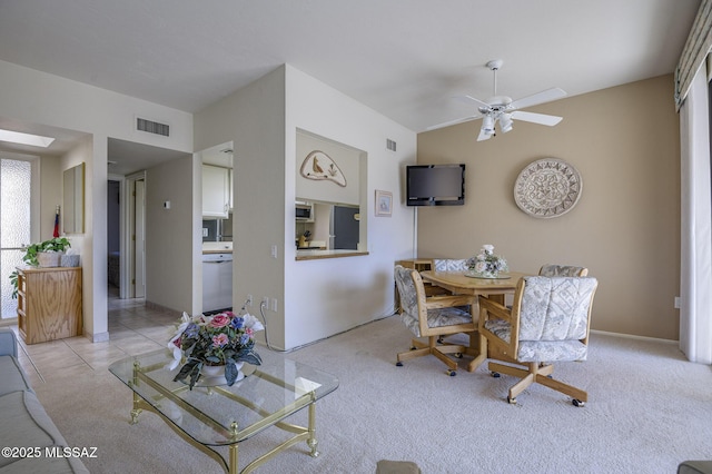 dining area with lofted ceiling, light colored carpet, and ceiling fan