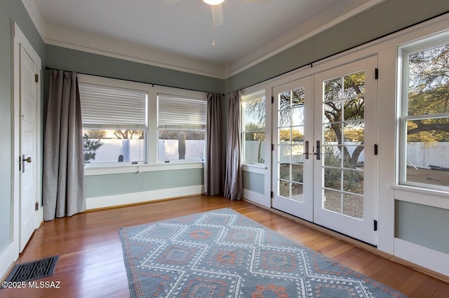 entryway with hardwood / wood-style flooring, plenty of natural light, and french doors