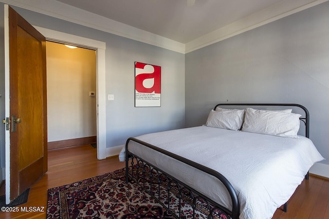 bedroom featuring hardwood / wood-style flooring and ornamental molding