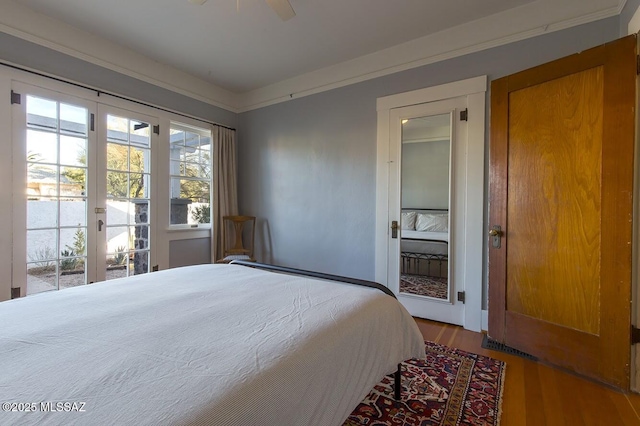 bedroom with french doors, wood-type flooring, access to outside, ornamental molding, and ceiling fan