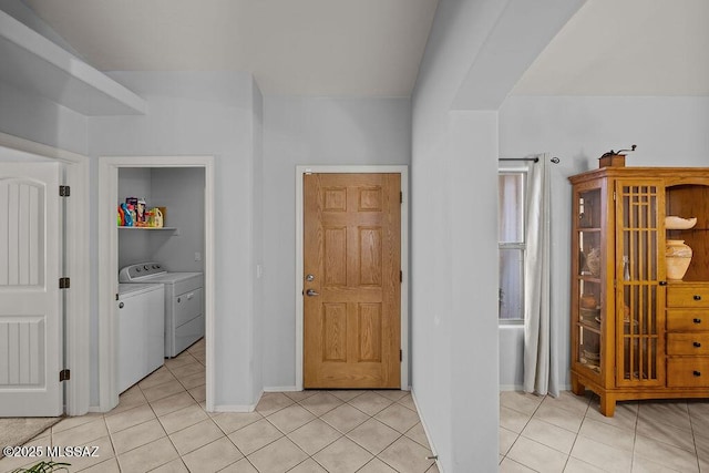 interior space with separate washer and dryer and light tile patterned flooring