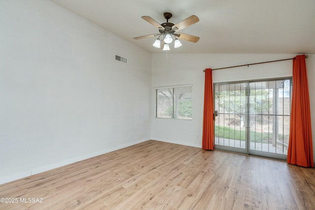 empty room featuring vaulted ceiling, ceiling fan, and light wood-type flooring