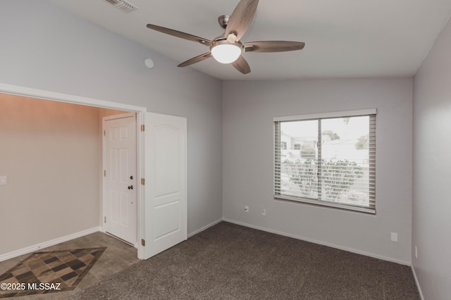 carpeted empty room featuring vaulted ceiling and ceiling fan