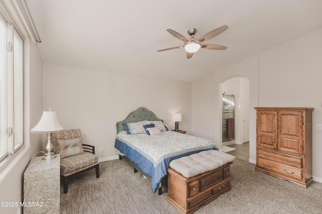 carpeted bedroom with ceiling fan and multiple windows