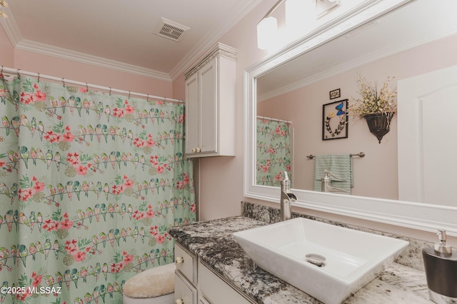 bathroom featuring vanity, ornamental molding, and toilet