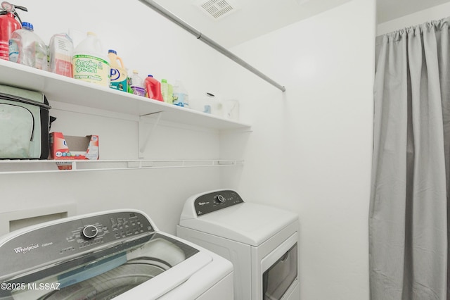 laundry room with washing machine and clothes dryer