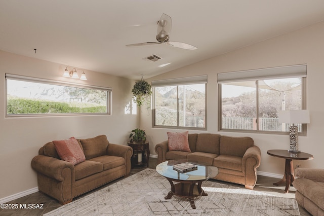 living room with ceiling fan and vaulted ceiling