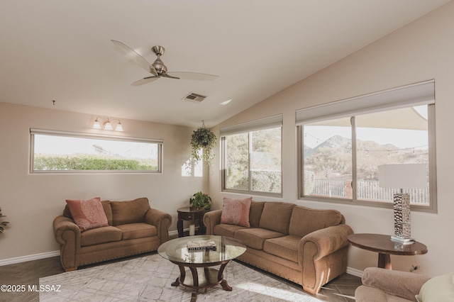 living room with vaulted ceiling, a mountain view, and ceiling fan