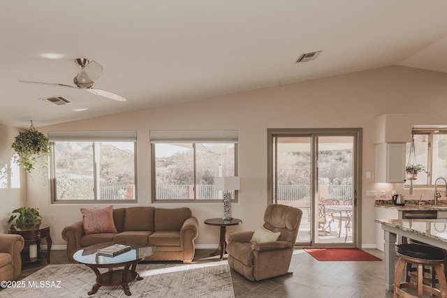 living room featuring vaulted ceiling, parquet flooring, sink, and ceiling fan