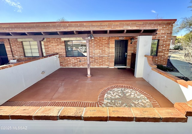 entrance to property featuring brick siding