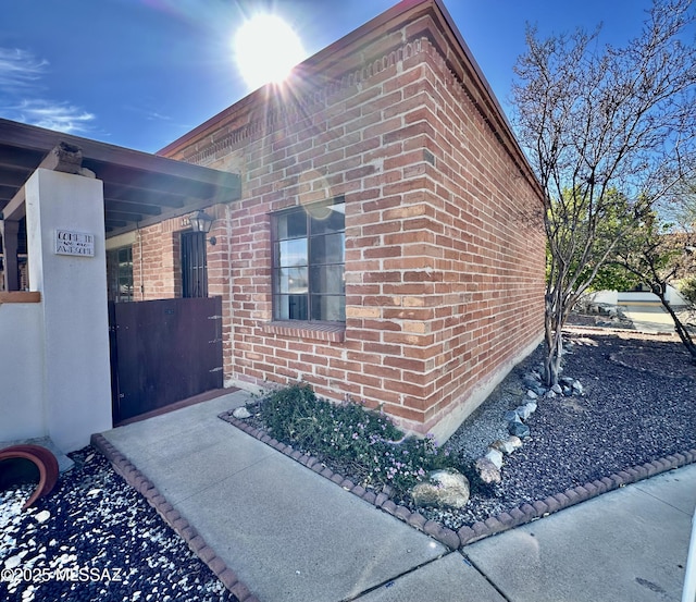 view of side of property featuring brick siding