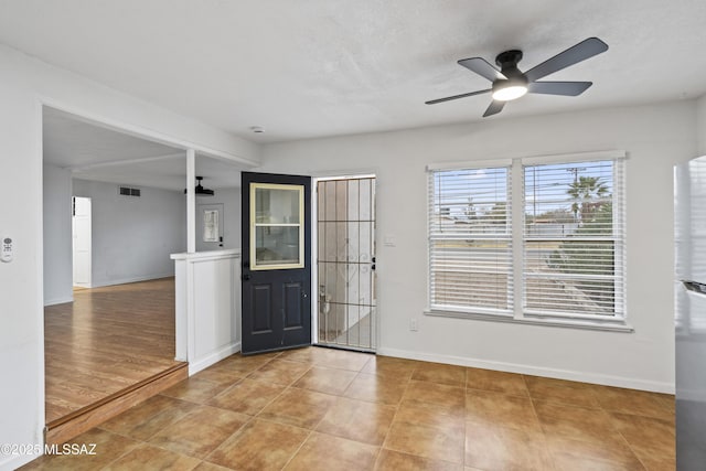 entrance foyer featuring light tile patterned floors, visible vents, baseboards, and ceiling fan