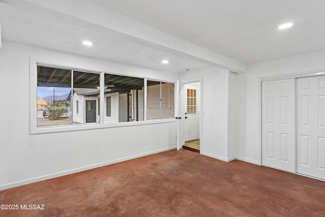 unfurnished bedroom with concrete floors and a closet