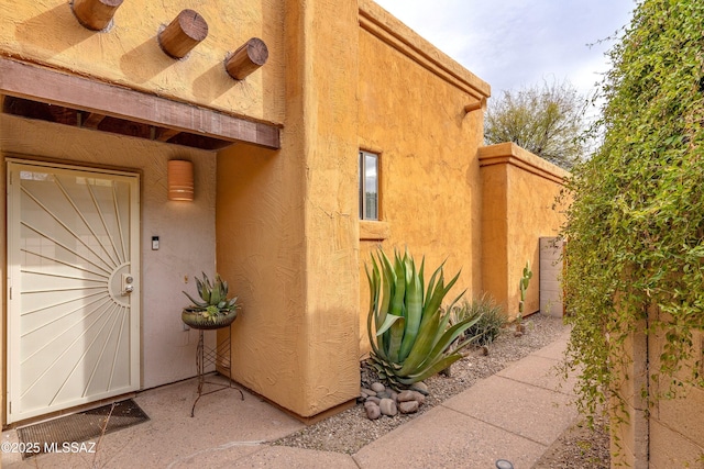 doorway to property with stucco siding