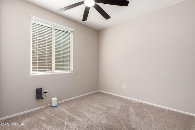 carpeted spare room featuring ceiling fan