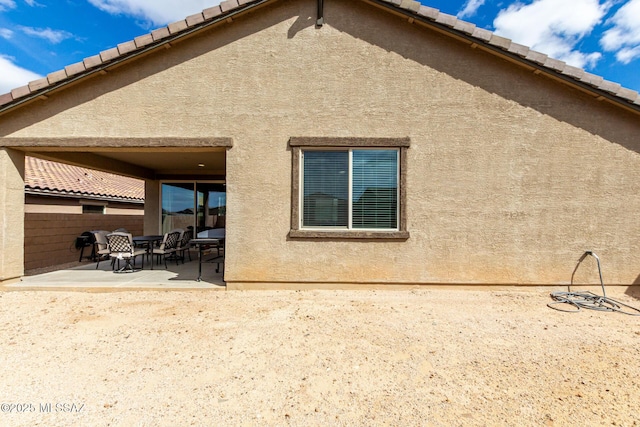 back of property featuring a patio