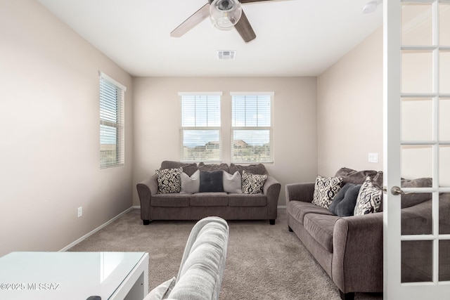 carpeted living room featuring ceiling fan