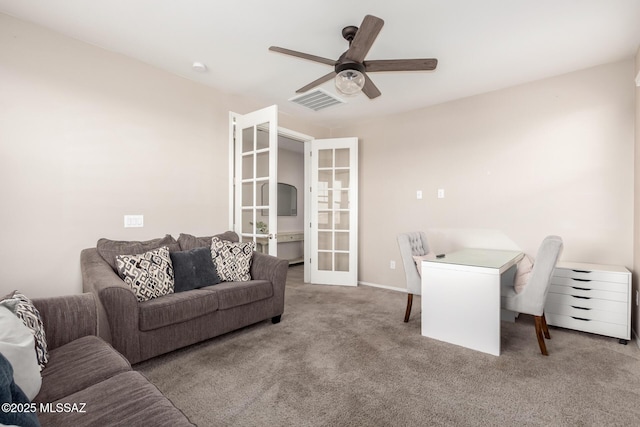 office space with french doors, ceiling fan, and light carpet