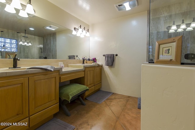 bathroom featuring vanity, tile patterned floors, and tiled shower