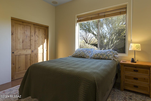 bedroom with light tile patterned floors