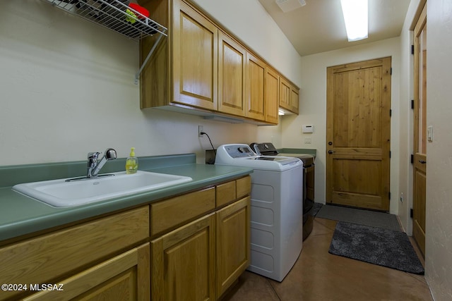 laundry room with separate washer and dryer, sink, and cabinets