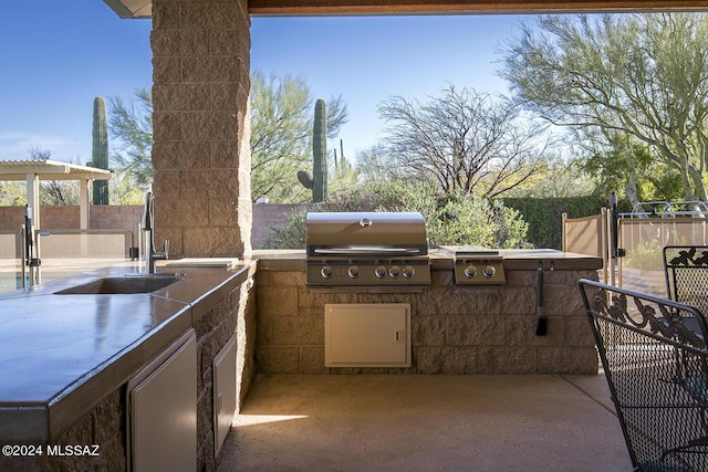 view of patio featuring area for grilling and sink