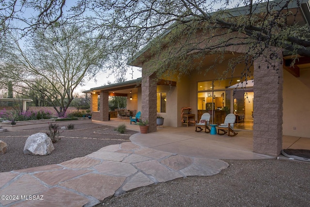 view of patio terrace at dusk