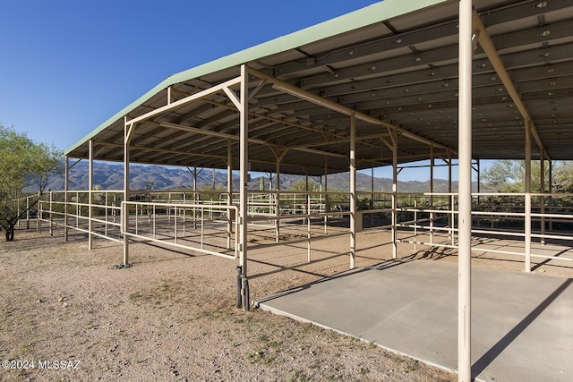 view of stable featuring a mountain view and a rural view