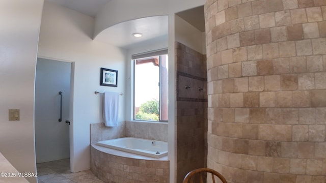 bathroom featuring tile patterned flooring and independent shower and bath