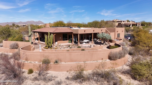 rear view of property with a patio and a mountain view