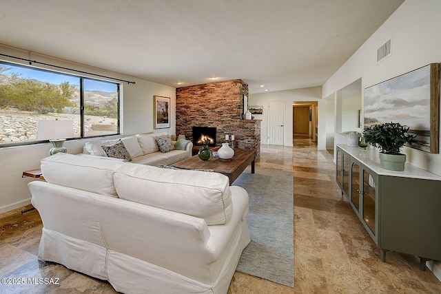 living room with a fireplace and vaulted ceiling