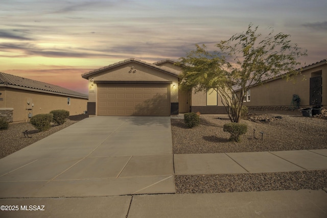 1599 W Cottonwood Bluffs Dr, Benson, AZ 85602 - view of front facade with driveway, stucco siding, and a garage