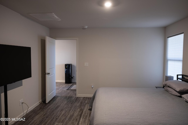 bedroom featuring dark wood-style flooring, visible vents, and baseboards