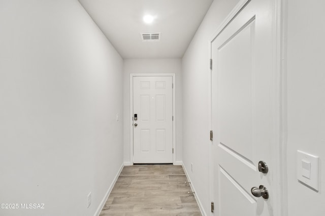 1599 W Cottonwood Bluffs Dr, Benson, AZ 85602 - doorway featuring light wood-style floors and baseboards