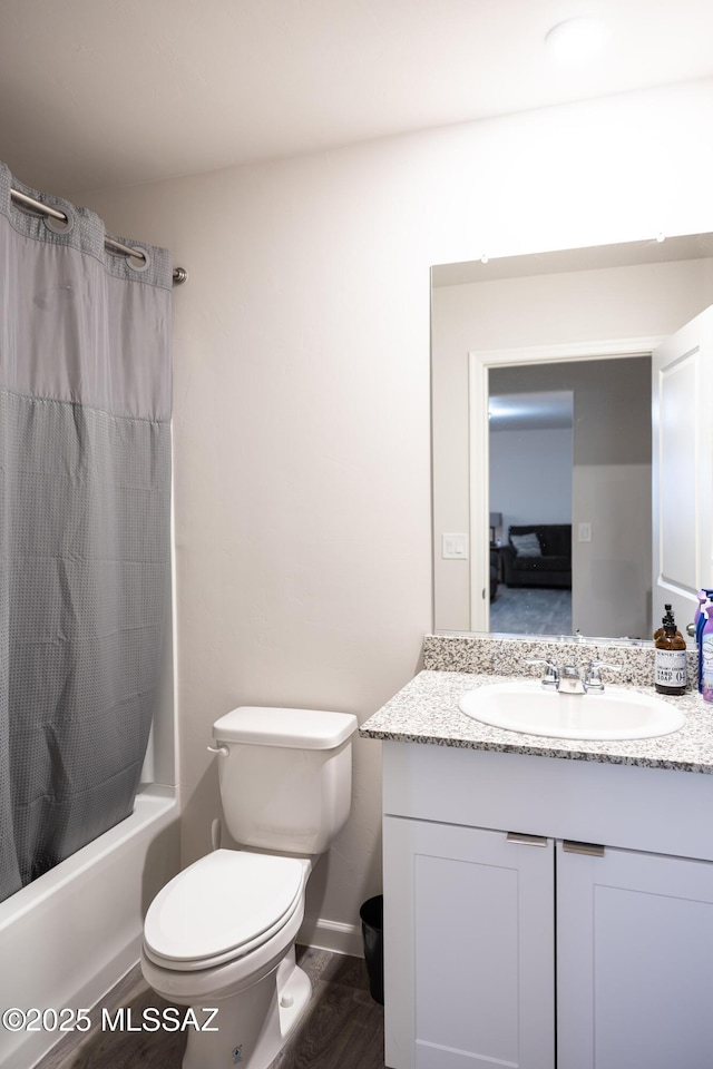 bathroom with toilet, vanity, and shower / tub combo with curtain