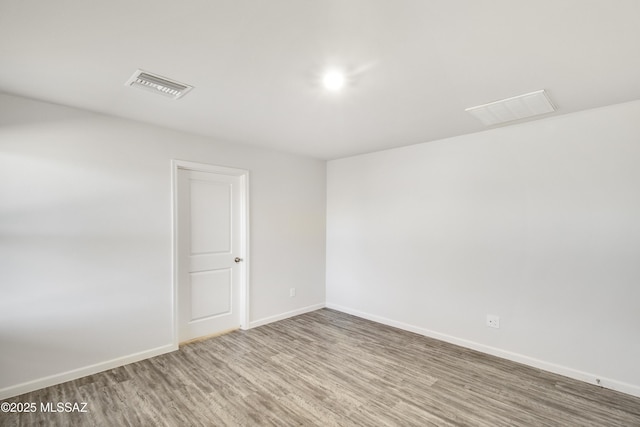 1599 W Cottonwood Bluffs Dr, Benson, AZ 85602 - unfurnished room featuring wood finished floors and baseboards