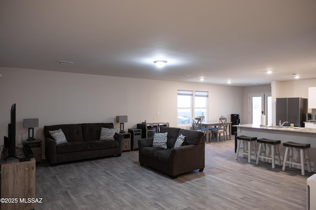 living area featuring wood finished floors and visible vents