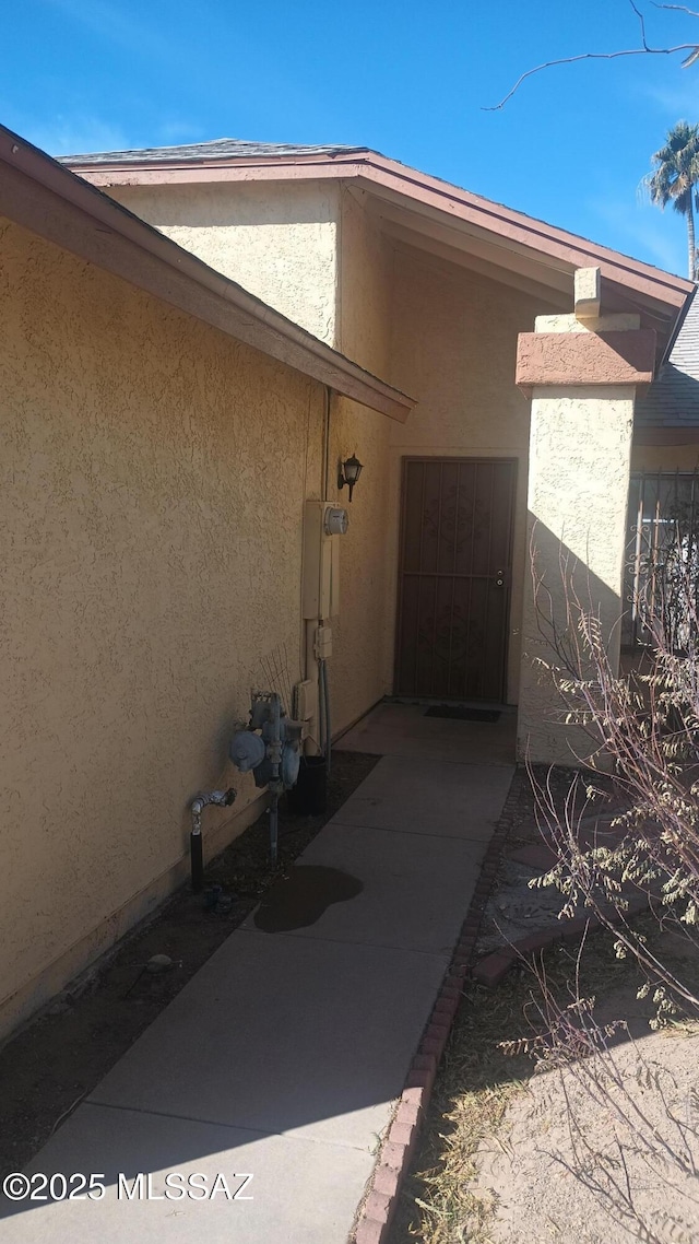 entrance to property with stucco siding