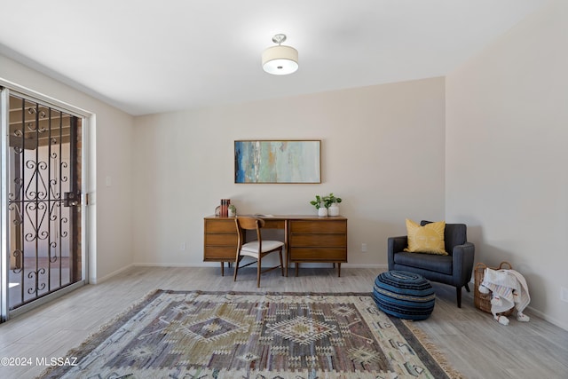 home office with light hardwood / wood-style flooring