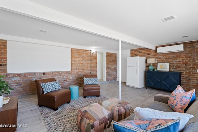 living room with hardwood / wood-style flooring, brick wall, a wall mounted AC, and beam ceiling
